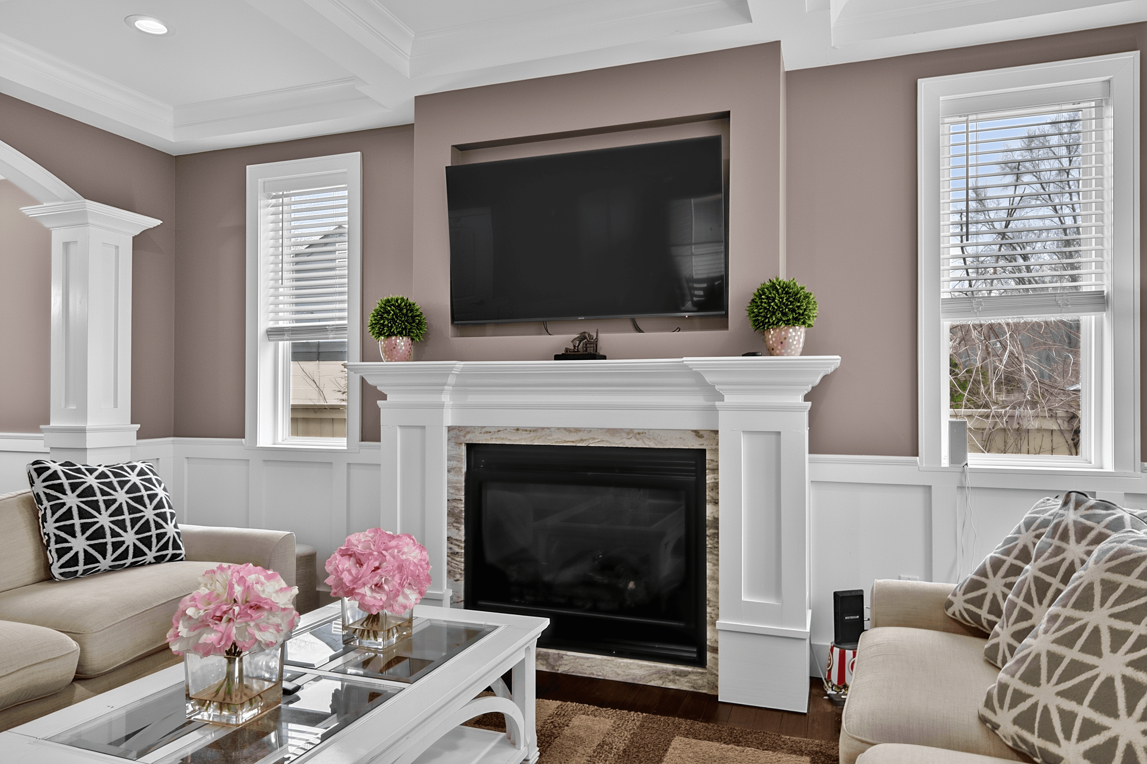 Final HDR merge of a real-estate living room — windows pulled, sky replaced, fireplace enhanced, glare removed, MLS-ready